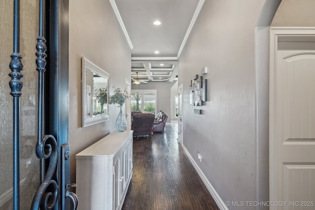 corridor featuring coffered ceiling, ornamental molding, and dark hardwood / wood-style floors