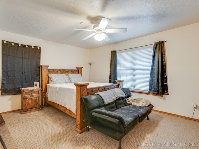 carpeted bedroom featuring ceiling fan and a textured ceiling