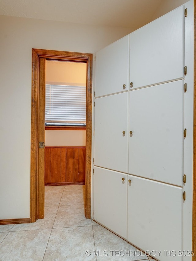 hallway featuring light tile patterned flooring