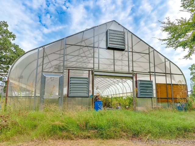 view of side of property featuring an outdoor structure