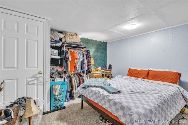 bedroom featuring a closet, a textured ceiling, and carpet