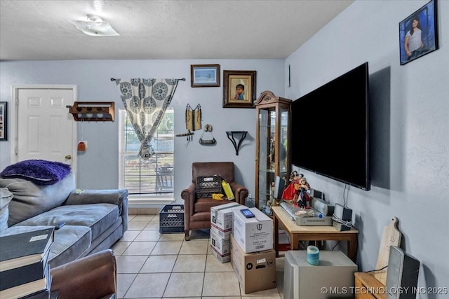 tiled living room featuring a textured ceiling