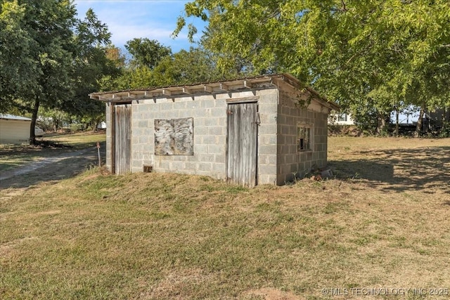 view of outbuilding featuring a lawn