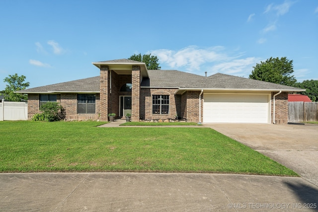 view of front of home featuring a garage and a front lawn