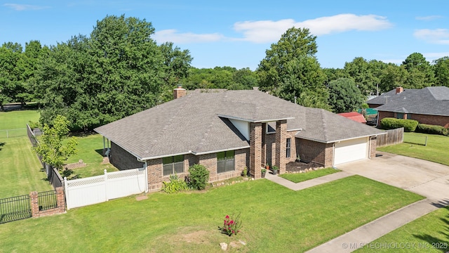 view of front of home with a garage and a front lawn