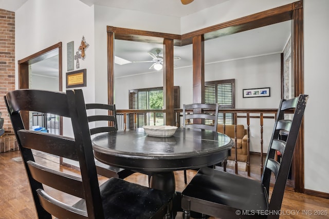 dining room with ceiling fan and wood-type flooring