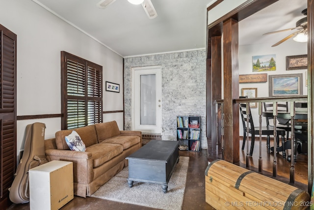 living room with ceiling fan and ornamental molding