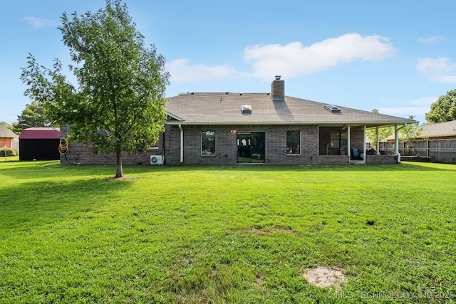 back of house featuring a yard