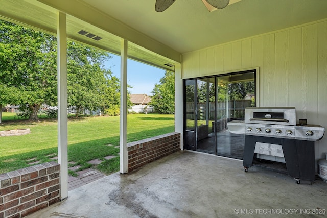 unfurnished sunroom featuring ceiling fan