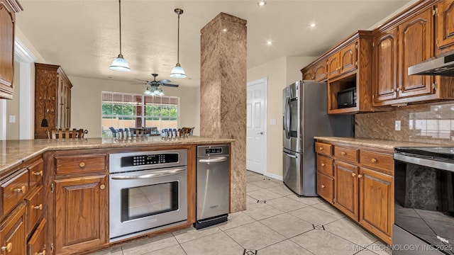 kitchen with light tile patterned flooring, hanging light fixtures, ceiling fan, stainless steel appliances, and decorative backsplash