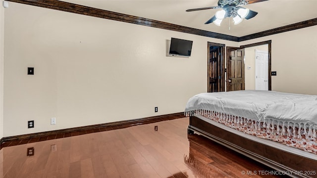 bedroom featuring crown molding, wood-type flooring, a closet, and ceiling fan