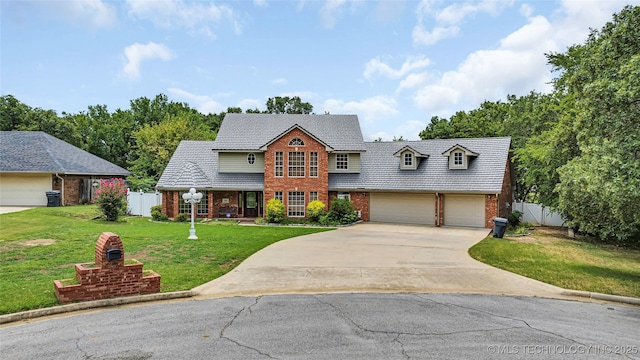 front facade featuring a garage and a front lawn