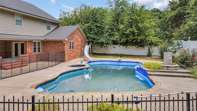 view of swimming pool featuring a patio area and a water slide