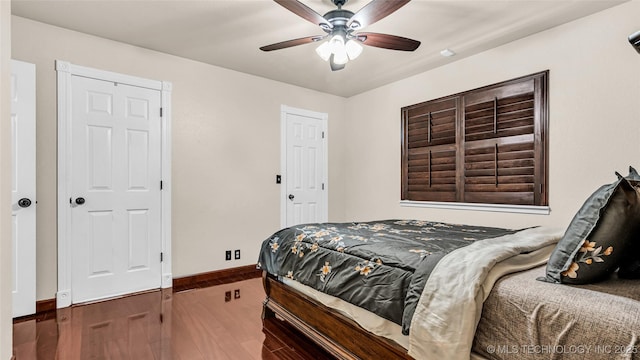 bedroom with ceiling fan and hardwood / wood-style floors