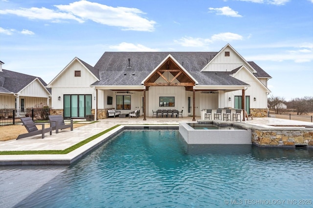 view of swimming pool with an in ground hot tub, an outdoor bar, ceiling fan, and a patio area