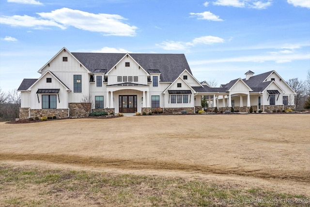 view of front of home featuring a front yard and french doors