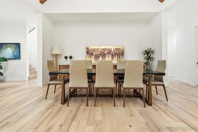 dining area featuring crown molding and light wood-type flooring