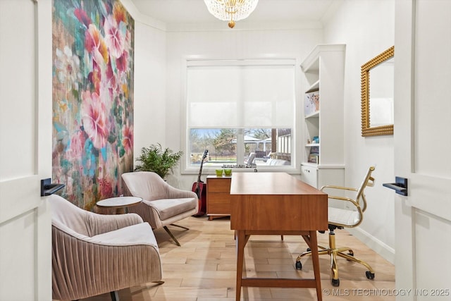 office space with crown molding, an inviting chandelier, and light hardwood / wood-style floors