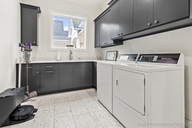 laundry area with sink, cabinets, and washing machine and clothes dryer