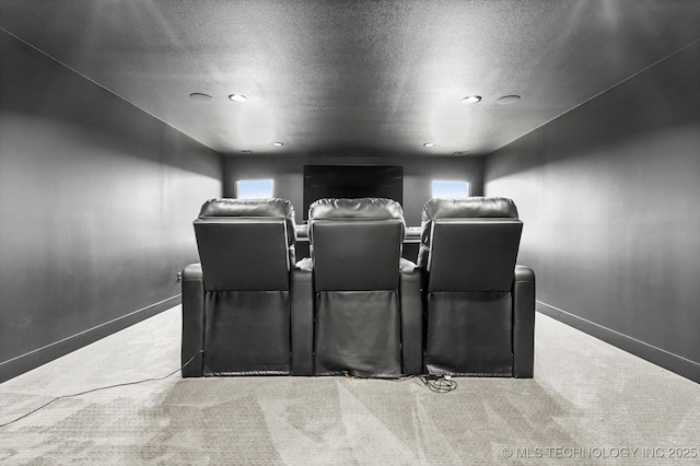 home theater with light colored carpet and a textured ceiling