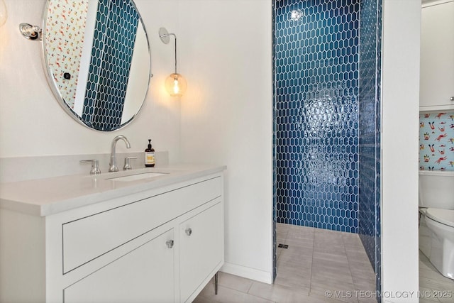 bathroom featuring vanity, tile patterned floors, and toilet