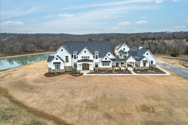 view of front of house featuring a front yard and a water view