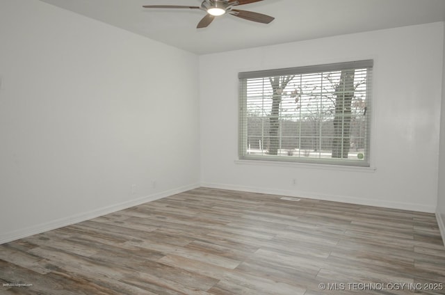 unfurnished room featuring light hardwood / wood-style flooring and ceiling fan