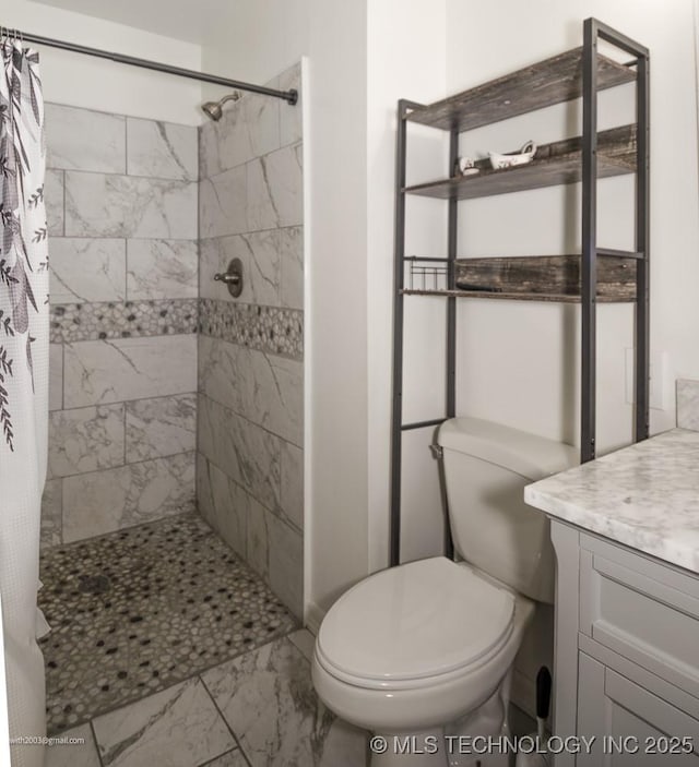 bathroom with toilet, vanity, and walk in shower