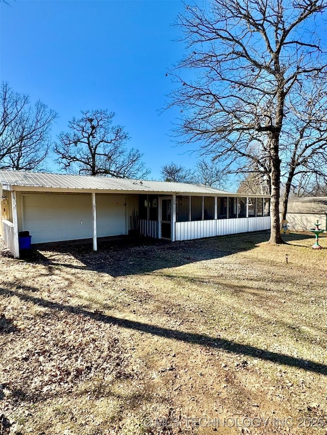 view of front of home featuring a front yard and a sunroom