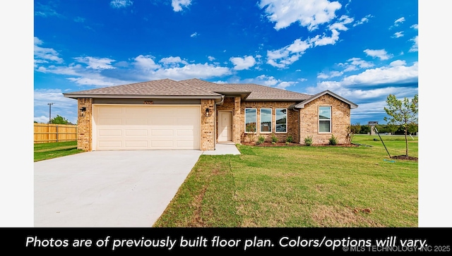 view of front of house featuring a garage and a front lawn