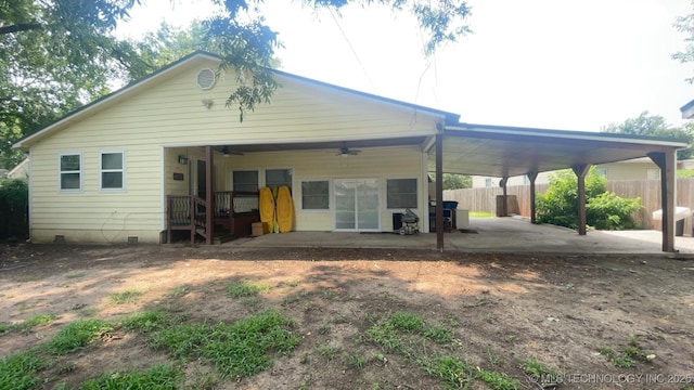 back of property with ceiling fan and a patio area