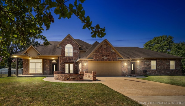 view of front of home featuring a garage and a lawn