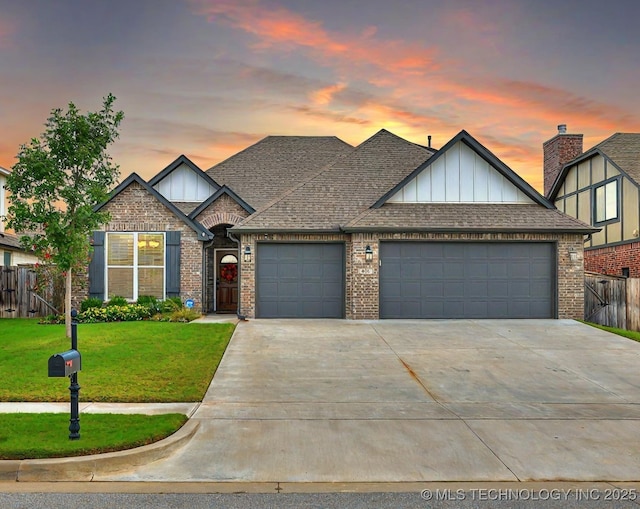 view of front of property featuring a garage and a lawn