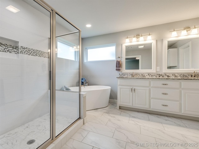 bathroom featuring vanity and shower with separate bathtub