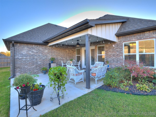 rear view of house with a yard, ceiling fan, and a patio area