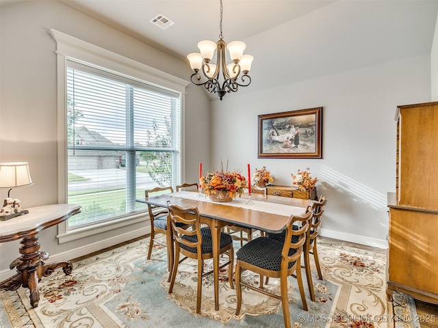 dining room featuring a chandelier and light wood-type flooring