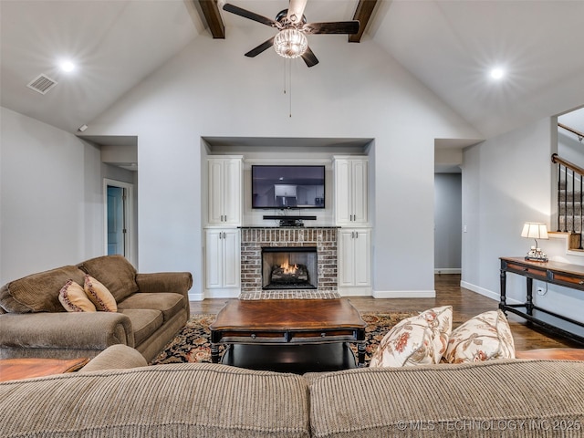 living room with a brick fireplace, hardwood / wood-style flooring, high vaulted ceiling, and beamed ceiling