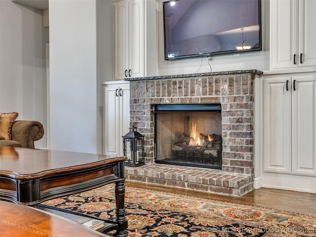 room details with a fireplace and wood finished floors