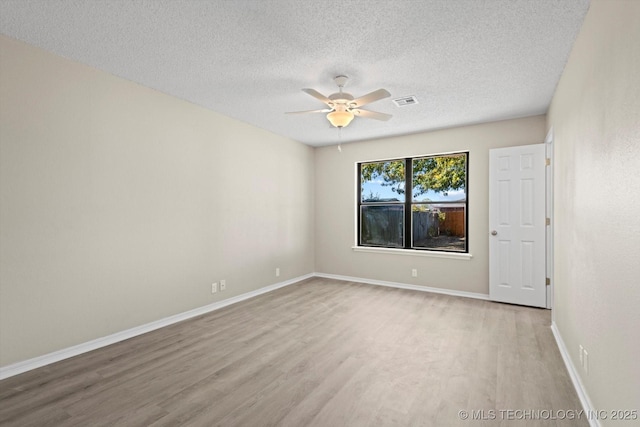 unfurnished room featuring a textured ceiling, ceiling fan, and light wood-type flooring