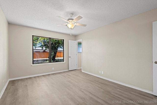 empty room with ceiling fan, a textured ceiling, and light hardwood / wood-style floors