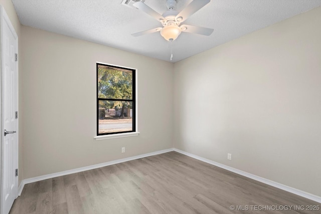 empty room with ceiling fan, a textured ceiling, and light hardwood / wood-style flooring