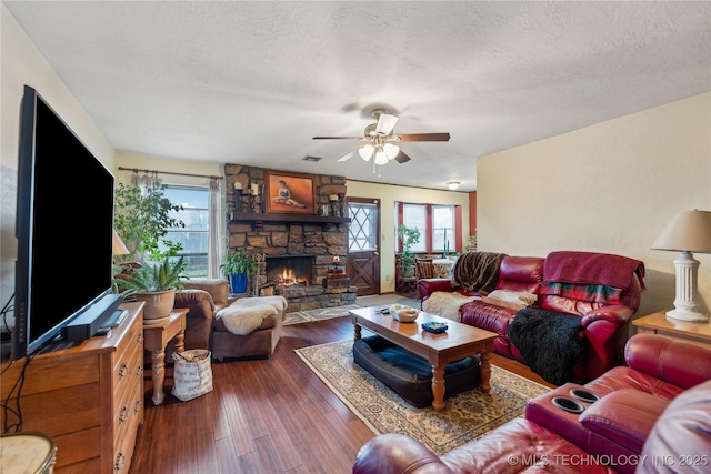 living room featuring dark hardwood / wood-style flooring, plenty of natural light, and a textured ceiling