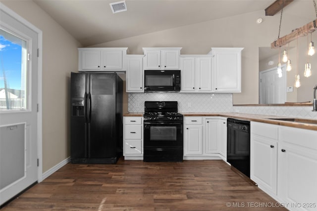 kitchen with sink, vaulted ceiling, black appliances, and white cabinets