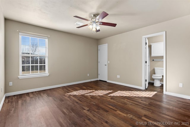 unfurnished bedroom featuring dark hardwood / wood-style flooring, ensuite bath, and ceiling fan