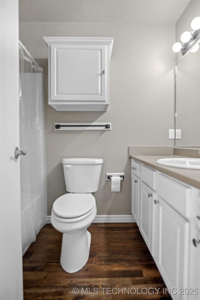 bathroom with vanity, toilet, and hardwood / wood-style floors