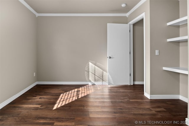 spare room with ornamental molding and dark wood-type flooring