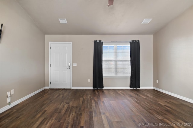 empty room with ceiling fan, dark hardwood / wood-style floors, and vaulted ceiling