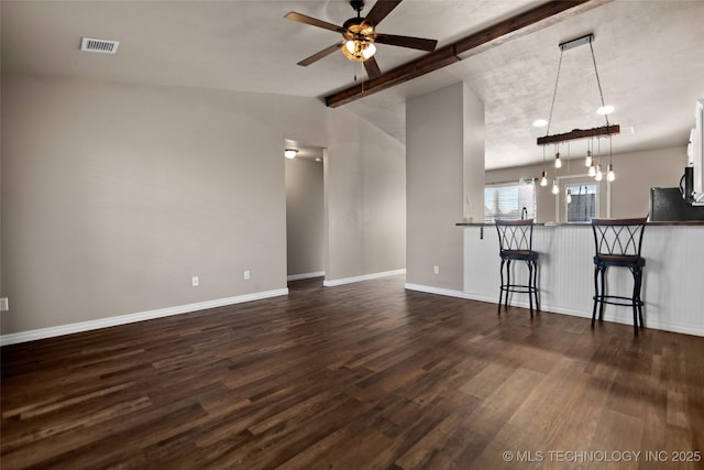 unfurnished living room with dark wood-type flooring, ceiling fan, and lofted ceiling with beams