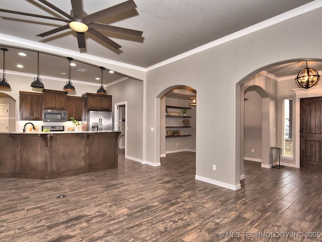 kitchen featuring pendant lighting, dark hardwood / wood-style flooring, dark brown cabinetry, and appliances with stainless steel finishes