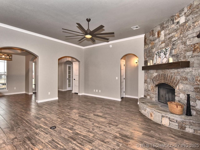 unfurnished living room featuring a fireplace, ornamental molding, dark hardwood / wood-style floors, and a textured ceiling